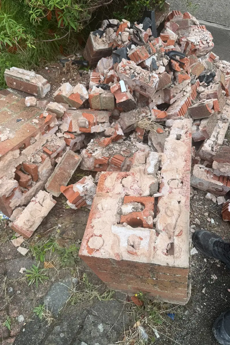 Bricks and broken pier sections from an old front garden wall after it was taken down.