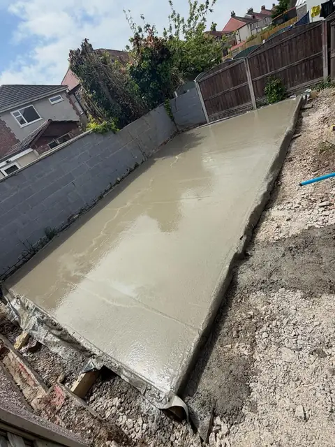 Freshly laid concrete base in a back garden