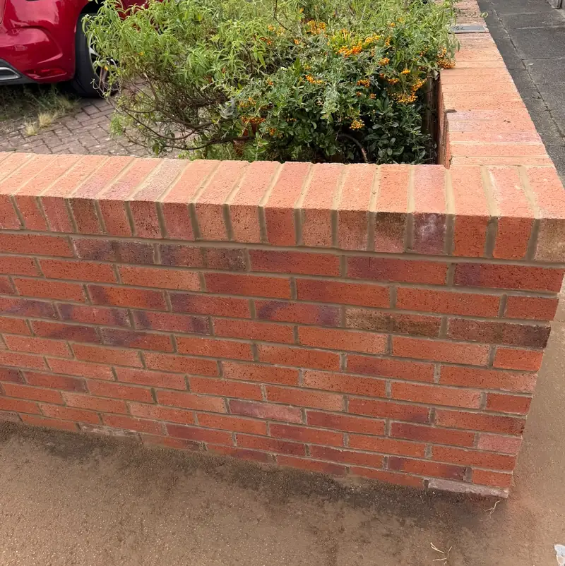 Rebuilt red brick front garden wall.