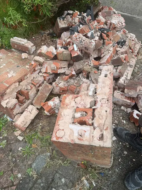 Bricks and broken pier sections from the old front garden wall after it was taken down.
