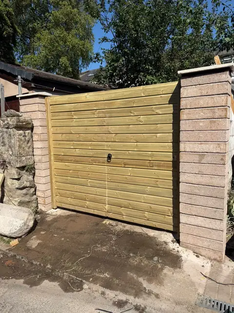 New timber double gates fitted between newly built block piers.
