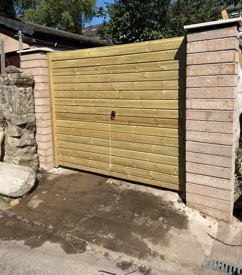 New timber double gates fitted between newly built block piers.