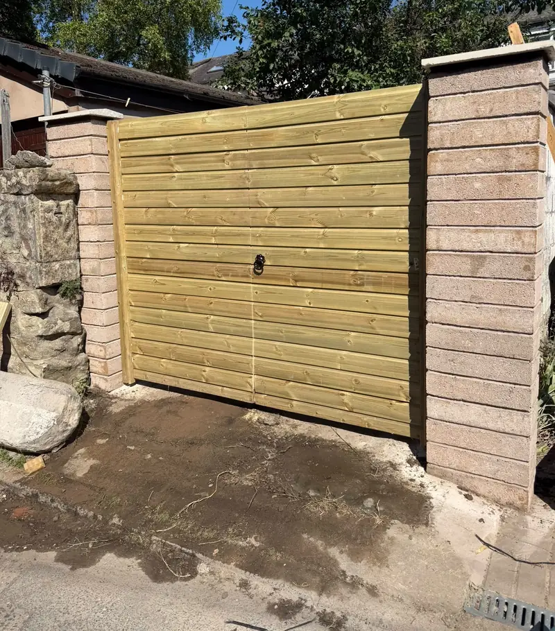 New timber double gates fitted between newly built block piers.